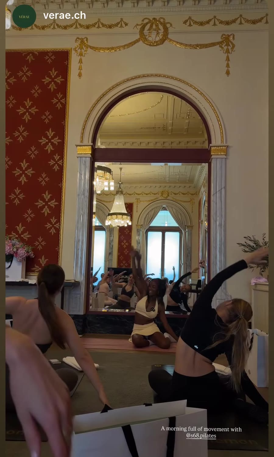 S68 women mid-stretch in the gilded Mo Luzern studio